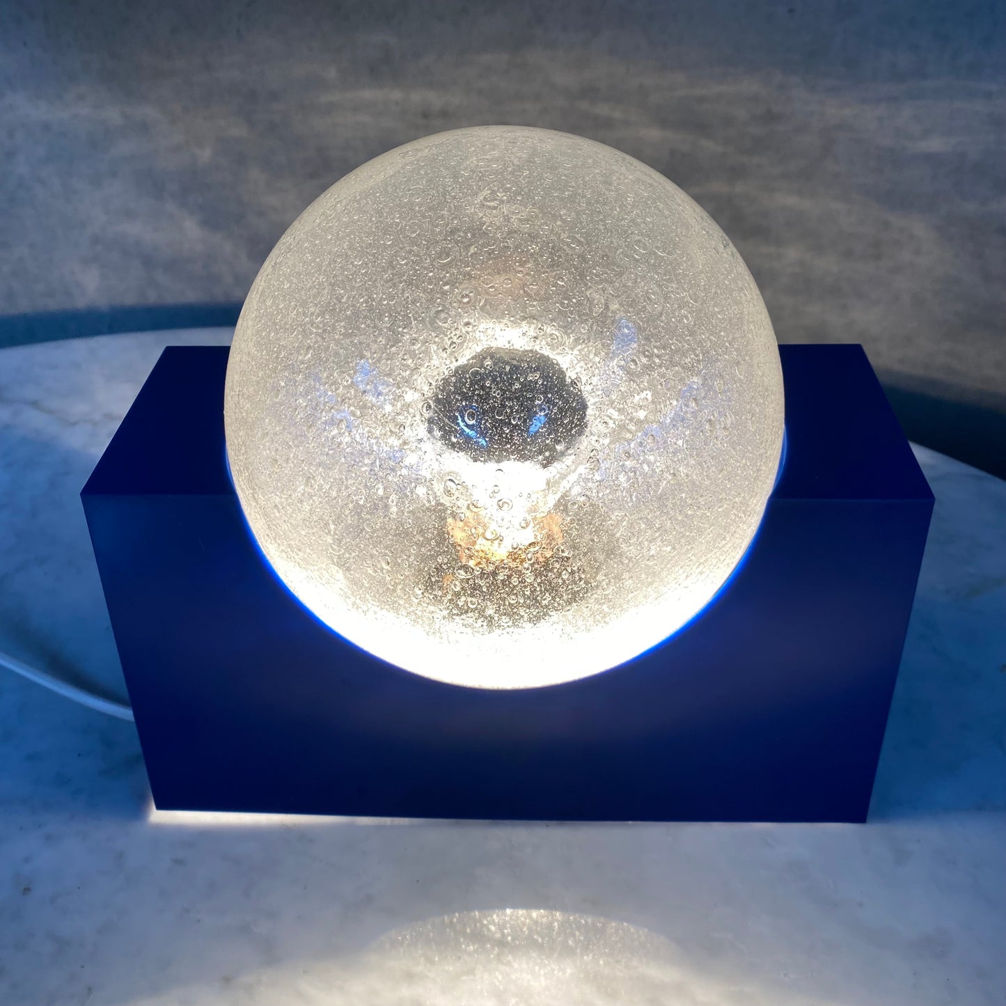 BRIGHT BLUE ACRYLIC BASE AND BUBBLE GLASS SPHERE BY RAAK AMSTERDAM, NETHERLANDS 1970S