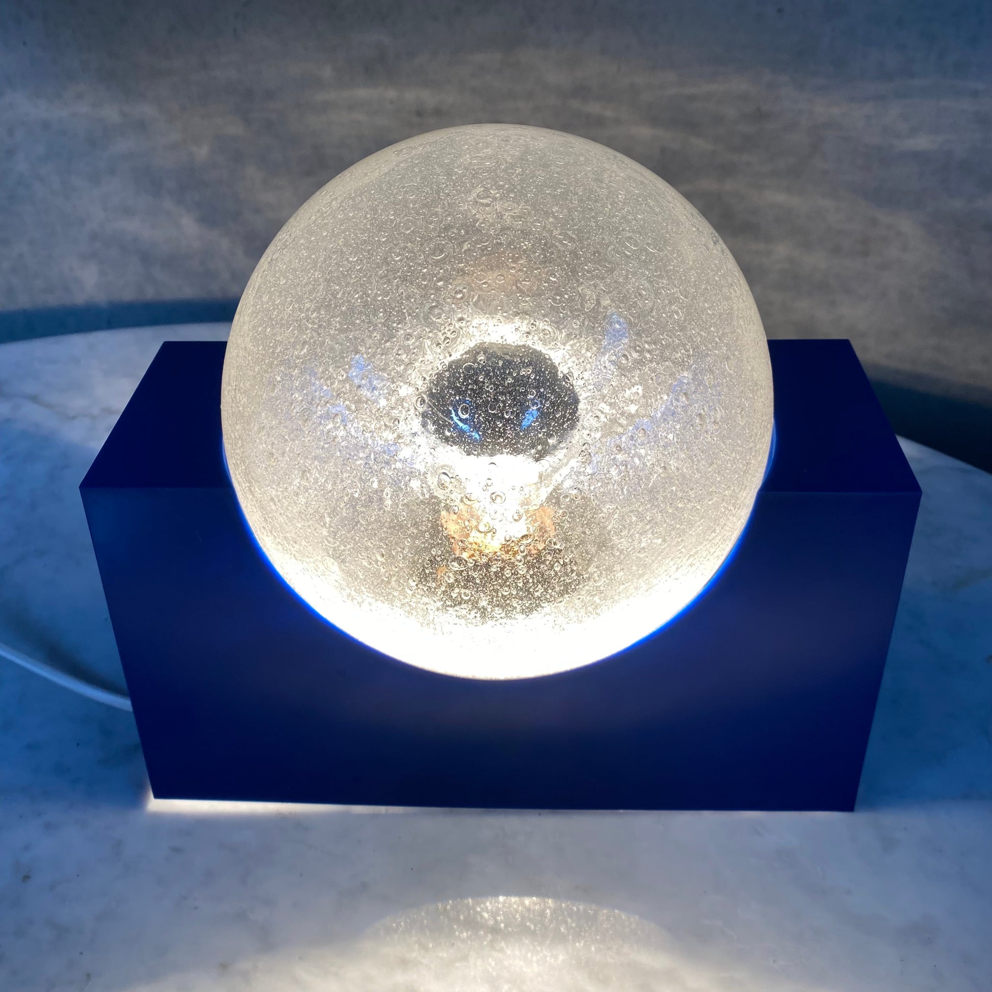 BRIGHT BLUE ACRYLIC BASE AND BUBBLE GLASS SPHERE BY RAAK AMSTERDAM, NETHERLANDS 1970S