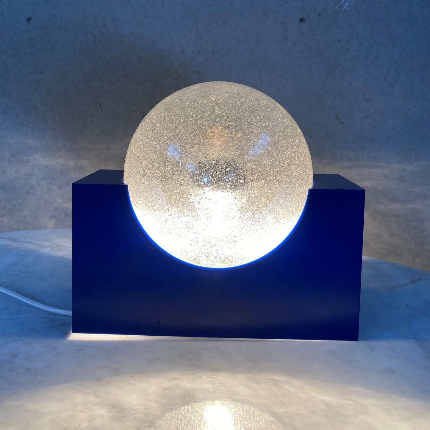 BRIGHT BLUE ACRYLIC BASE AND BUBBLE GLASS SPHERE BY RAAK AMSTERDAM, NETHERLANDS 1970S