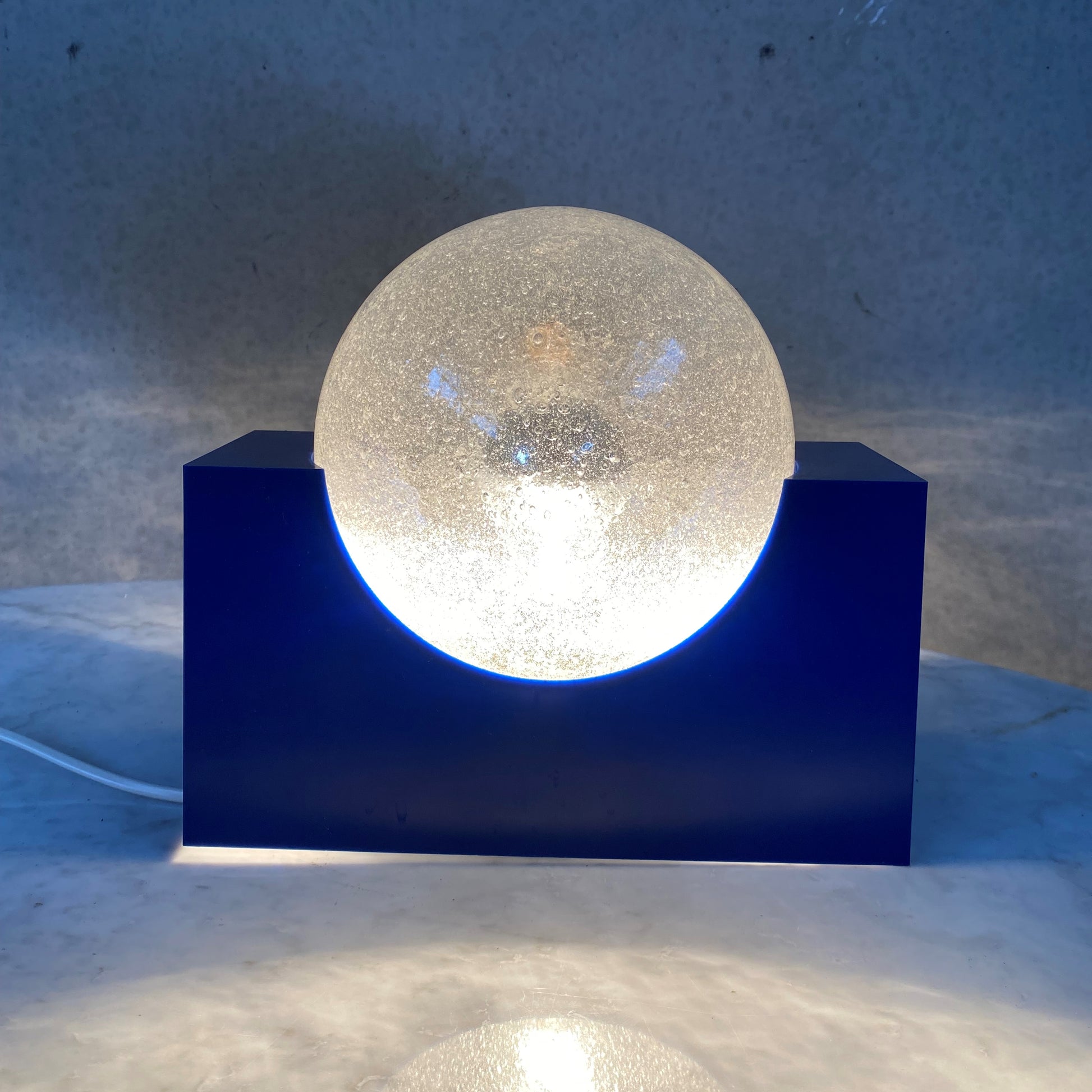 BRIGHT BLUE ACRYLIC BASE AND BUBBLE GLASS SPHERE BY RAAK AMSTERDAM, NETHERLANDS 1970S